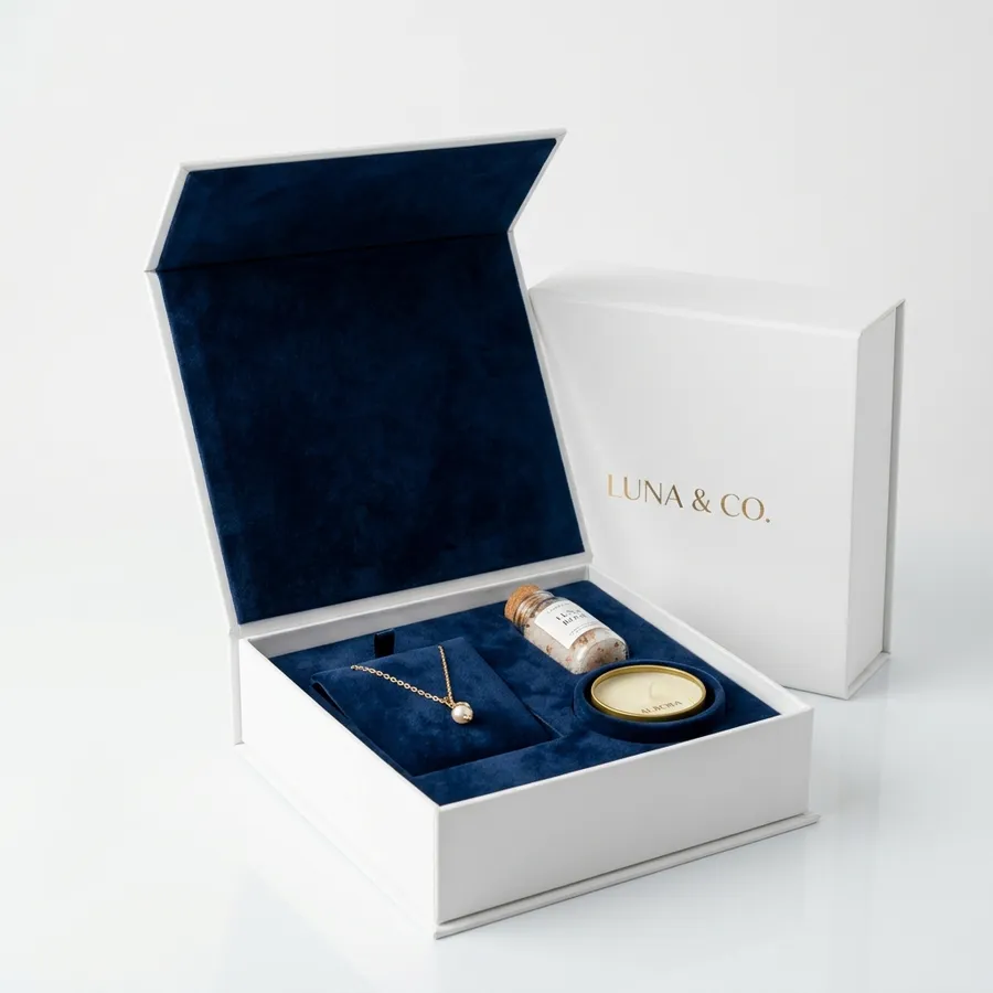 Luxury jewellery presentation box with navy velvet lining and gold foil brand mark