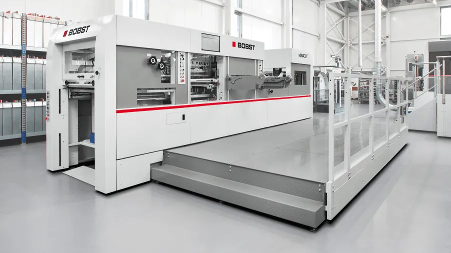 Bobst die-cutting line running folding cartons inside the Cubit production facility